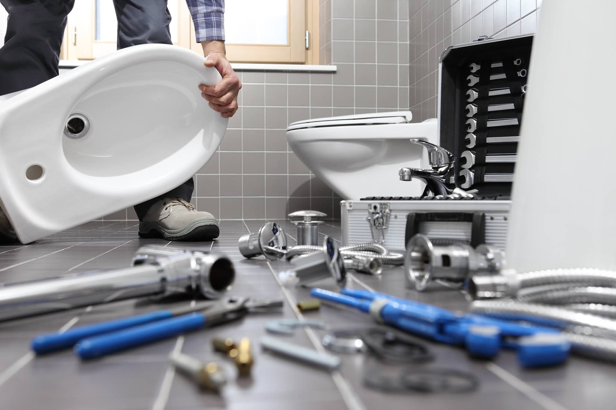 Licensed plumber installing a toilet in a San Jacinto, CA bathroom