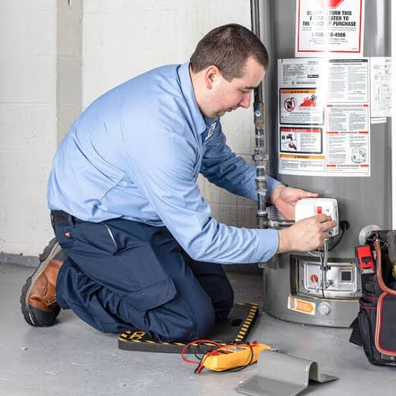 Plumber inspecting a water heater for signs of failure in San Jacinto, CA