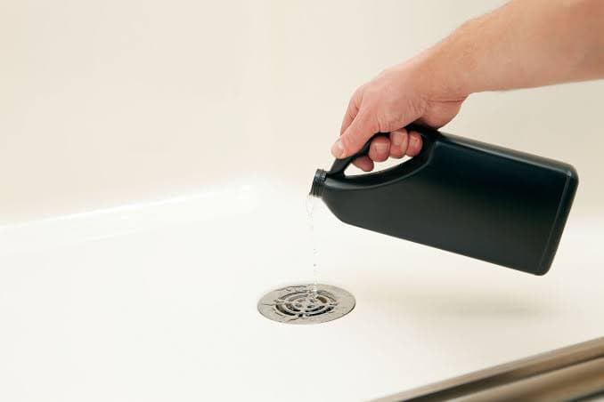 Liquid drain cleaner poured into a sink — why plumbers advise against it